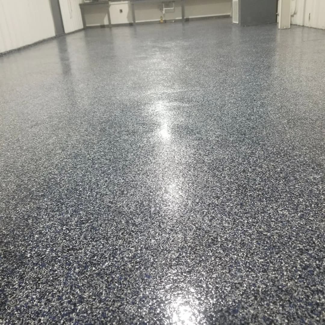 Shiny blue epoxy floor in a commercial space with smooth texture and reflective surface.