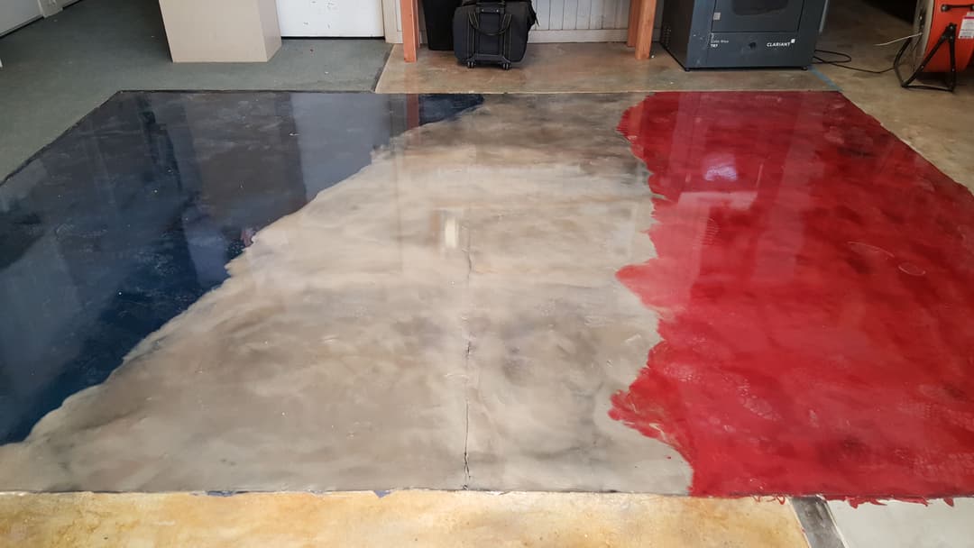 Abstract epoxy floor with red, white, and blue sections resembling a French flag design.