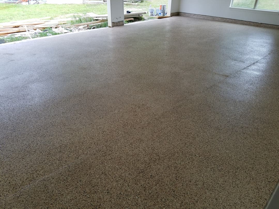 Polished concrete floor in an indoor space, featuring smooth, light-colored finish.