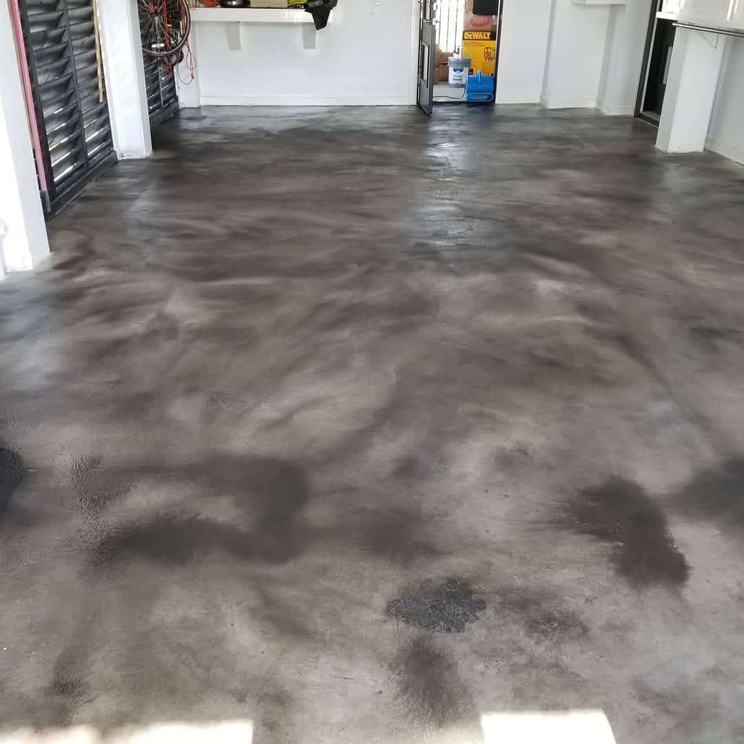 Polished concrete floor in a spacious garage with tools and equipment nearby.