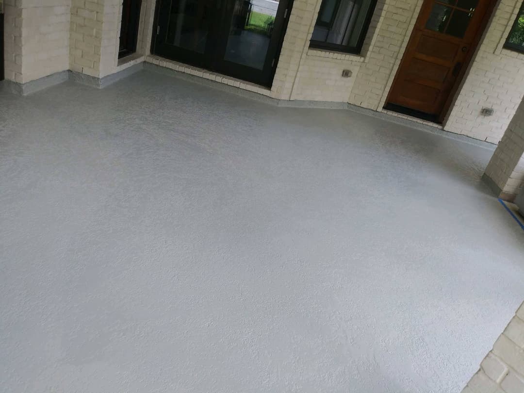 Freshly painted gray concrete porch with a clean, modern look, showcasing smooth texture and bright lighting.