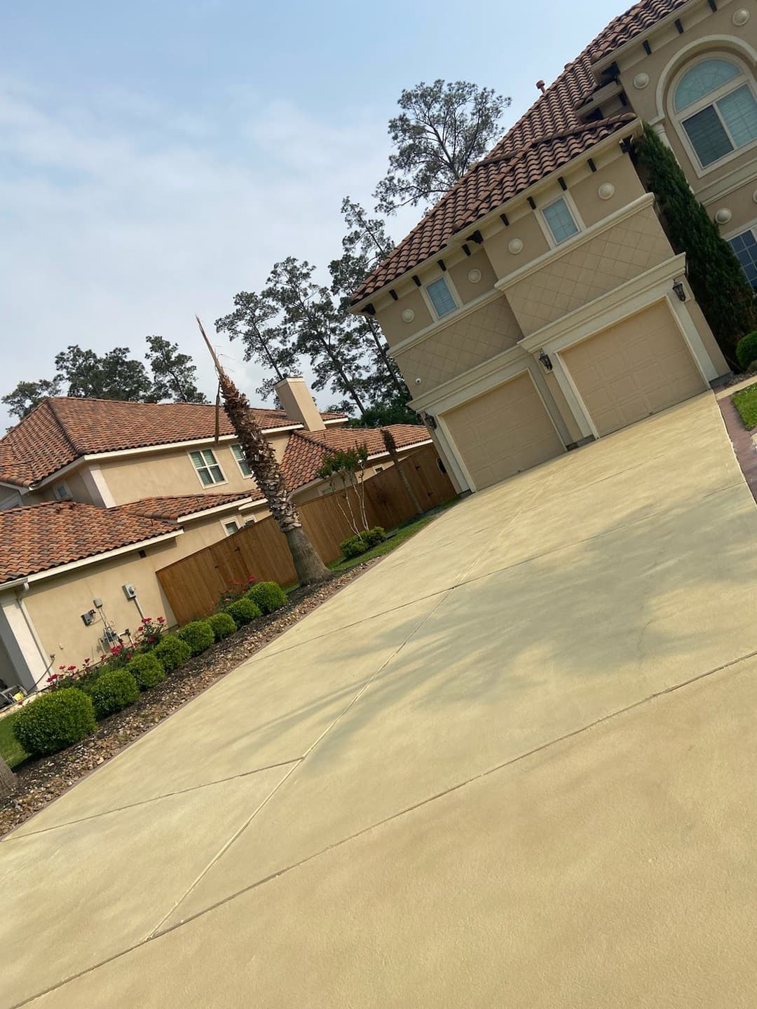 Luxury home exterior with manicured landscaping and a spacious driveway.