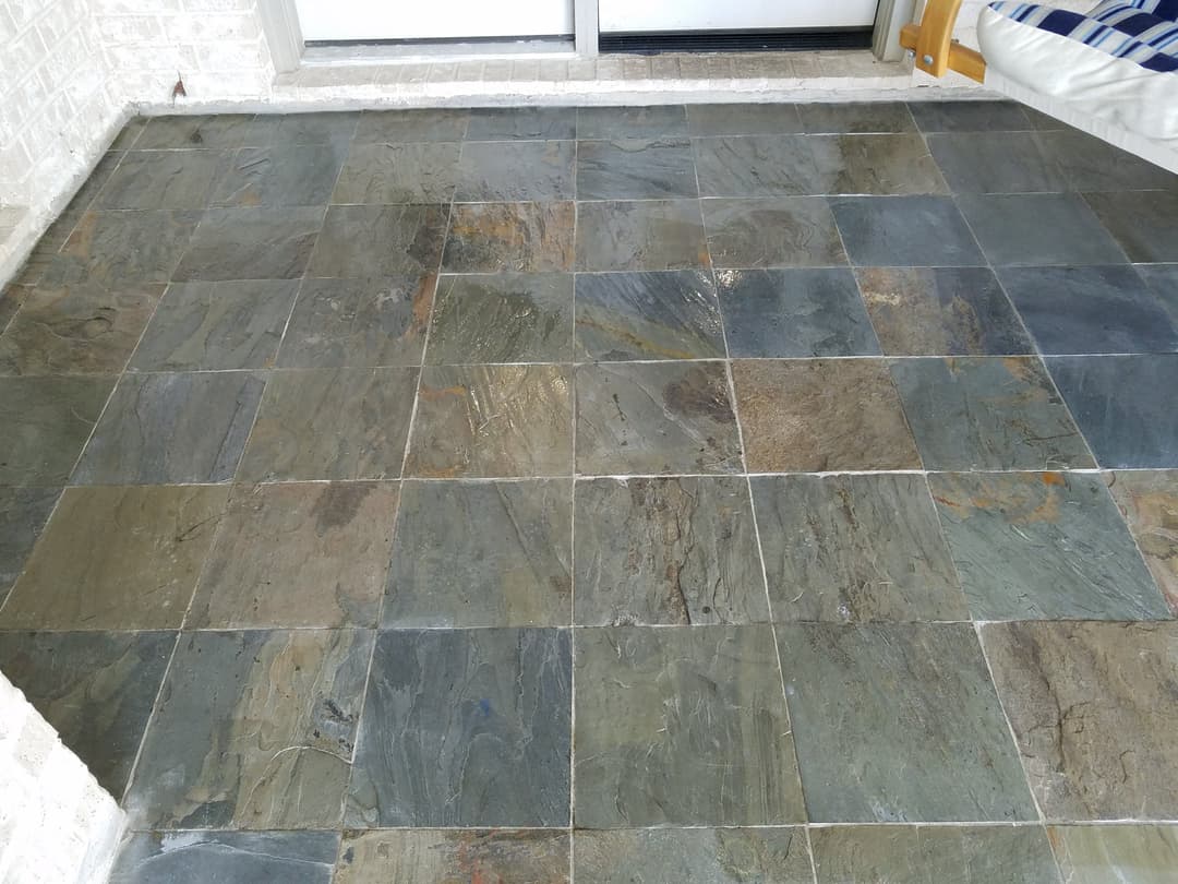 Elegant slate floor tiles with diverse colors and textures, enhancing indoor space aesthetics.