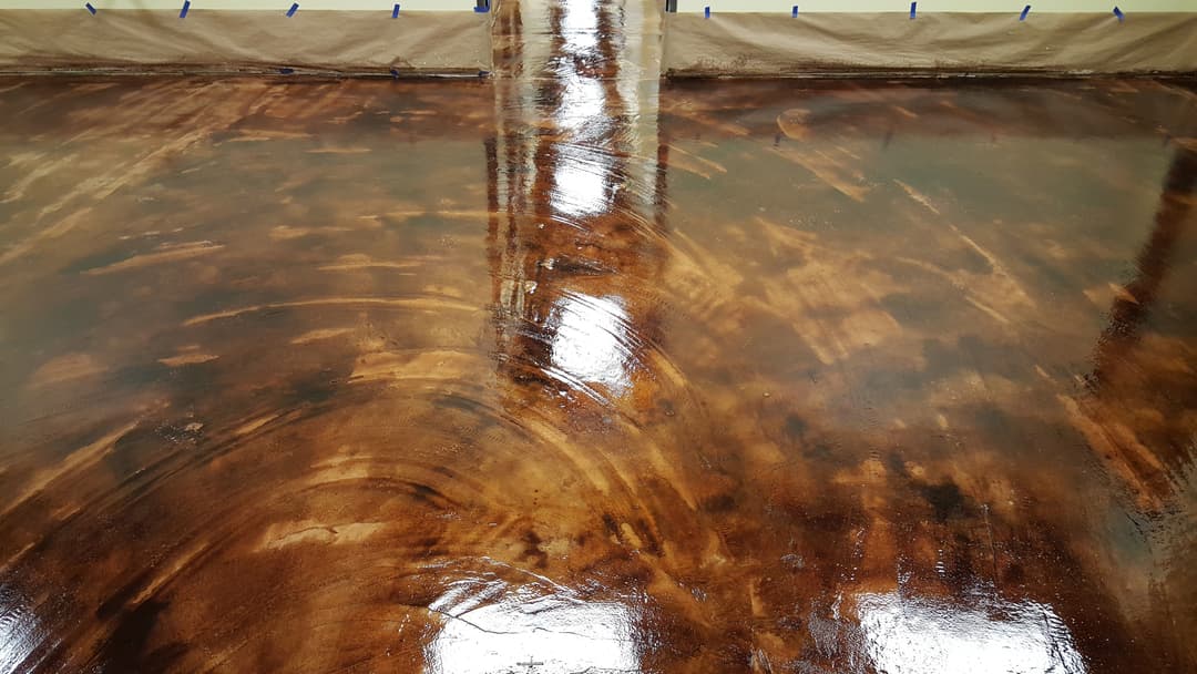 Shiny polished wood floor with rich brown tones and reflective surface in a renovated space.