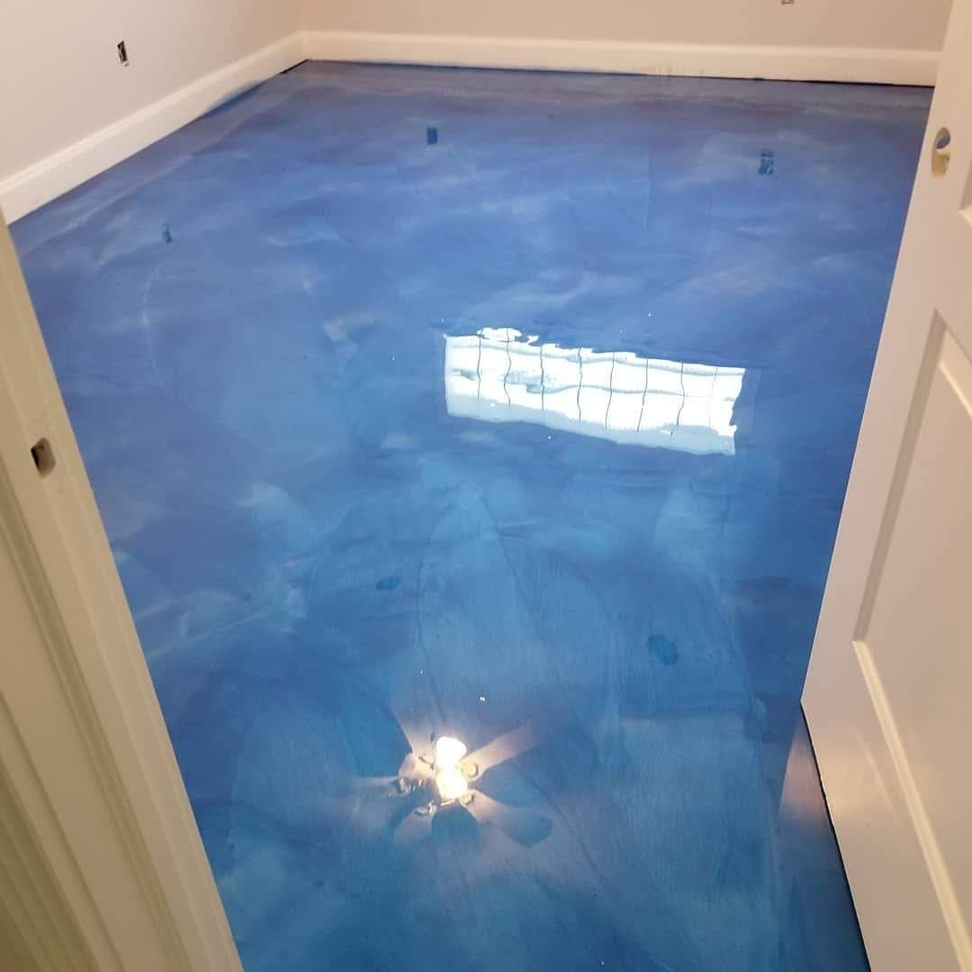 Bright blue epoxy floor in a modern room, showcasing a sleek and glossy finish.