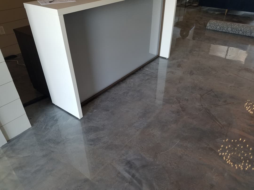 Modern interior with polished concrete flooring and a sleek reception desk.