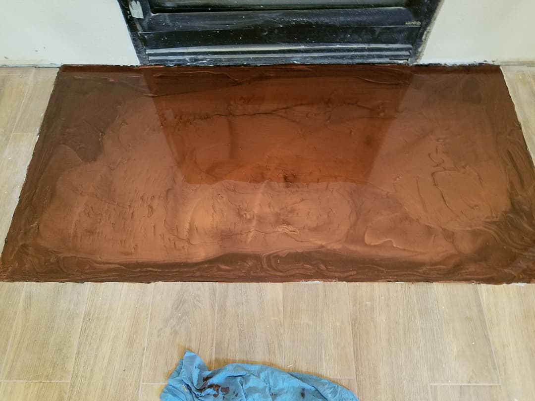 Copper epoxy floor coating in progress, showcasing smooth surface texture and sheen.