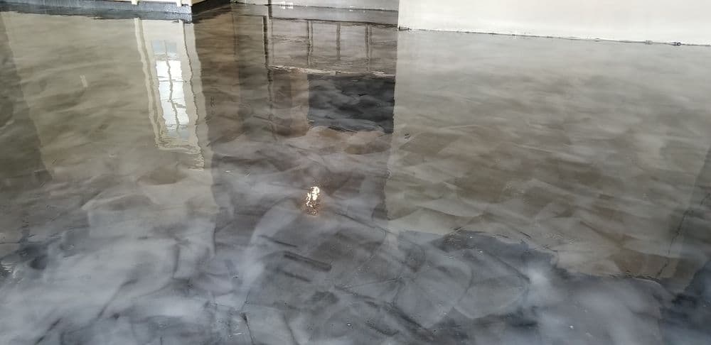 Polished concrete floor with a smooth, glossy finish reflecting natural light indoors.
